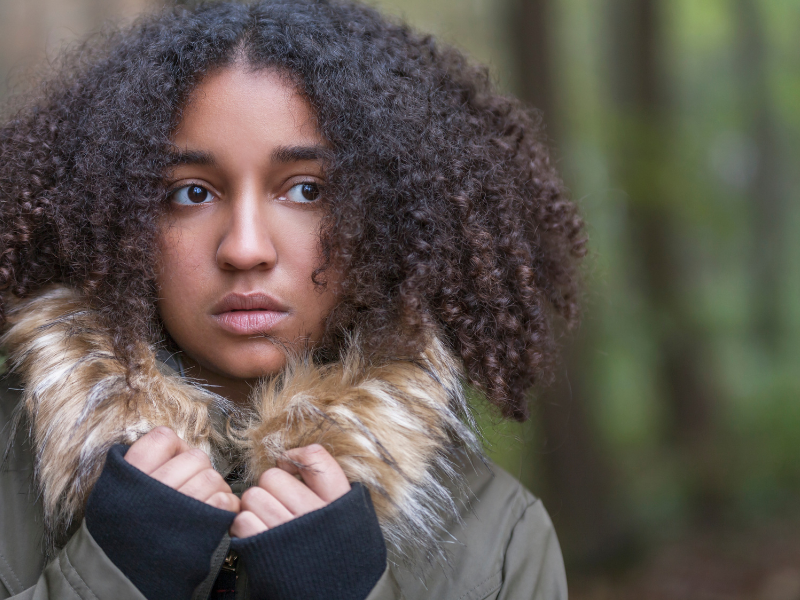 Teenage schoolgirls with backpacks walking together