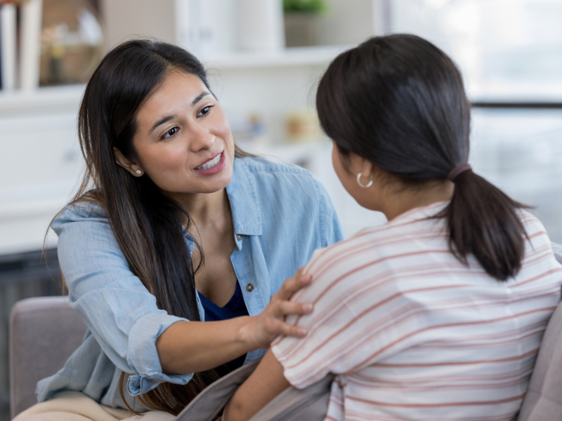Teenage schoolgirls with backpacks walking together